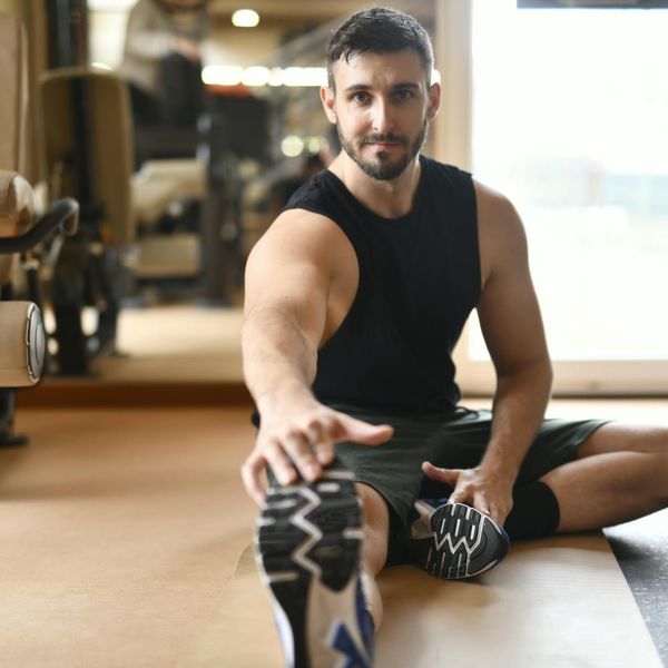Man in athletic wear stretching before a workout session.